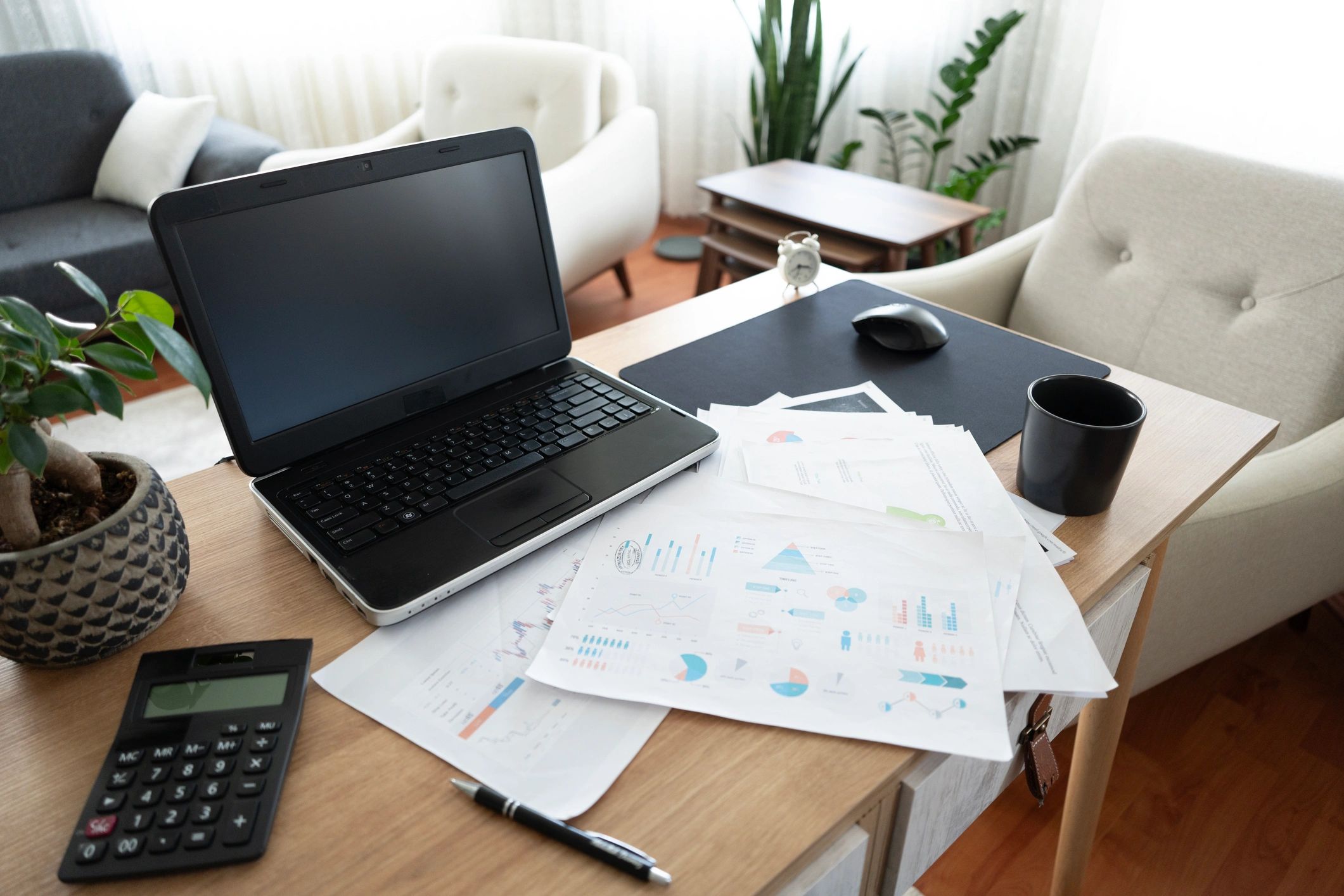 Laptop and financial reports on a desk