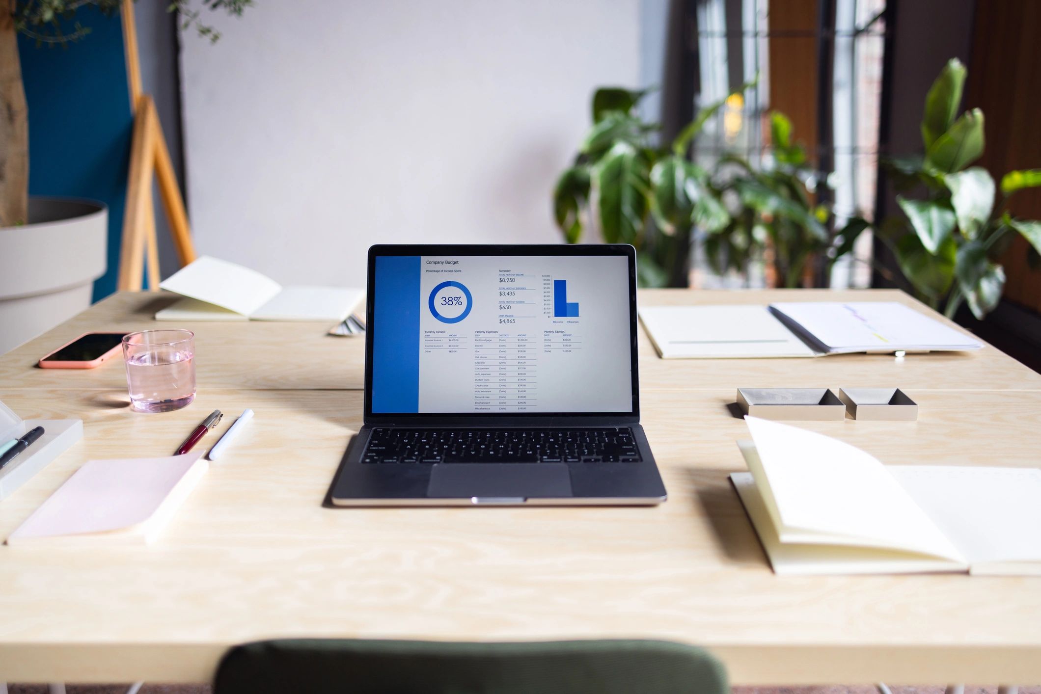 Minimal workspace with laptop and notebook